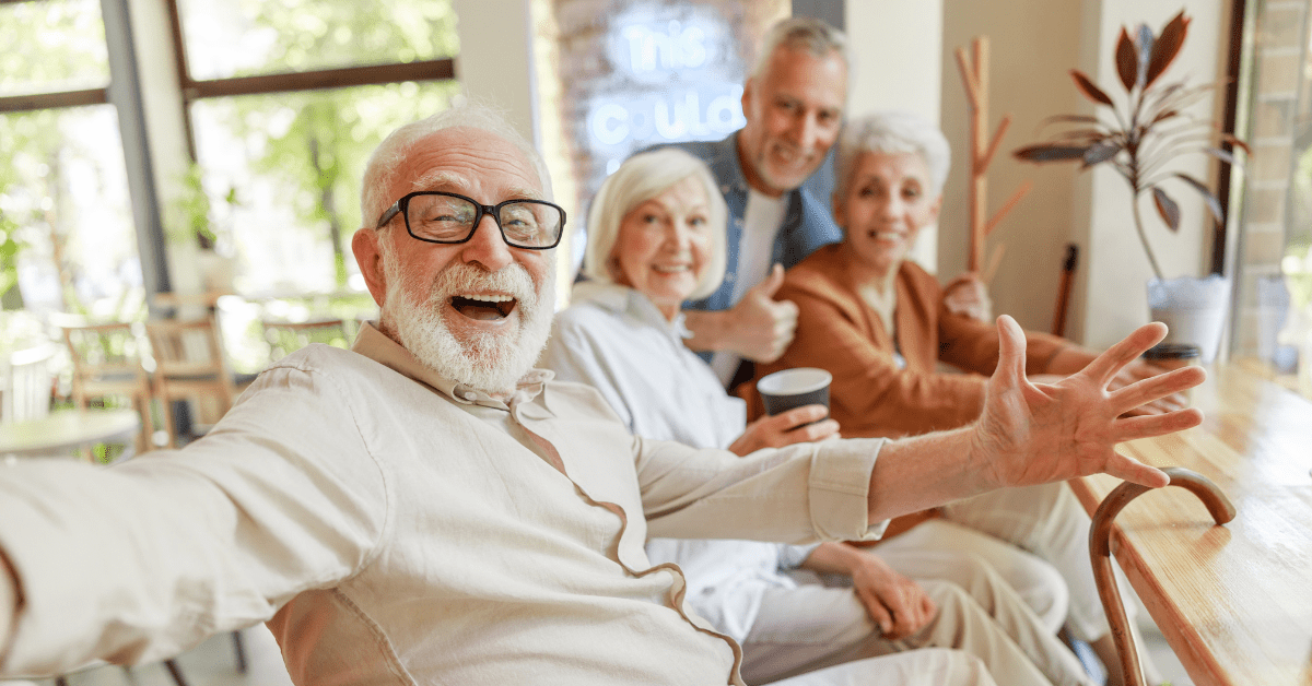 a group of older people welcomingly smiling